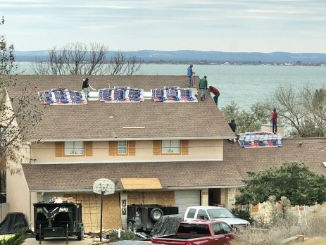 Professional roofers completing a roof replacement.